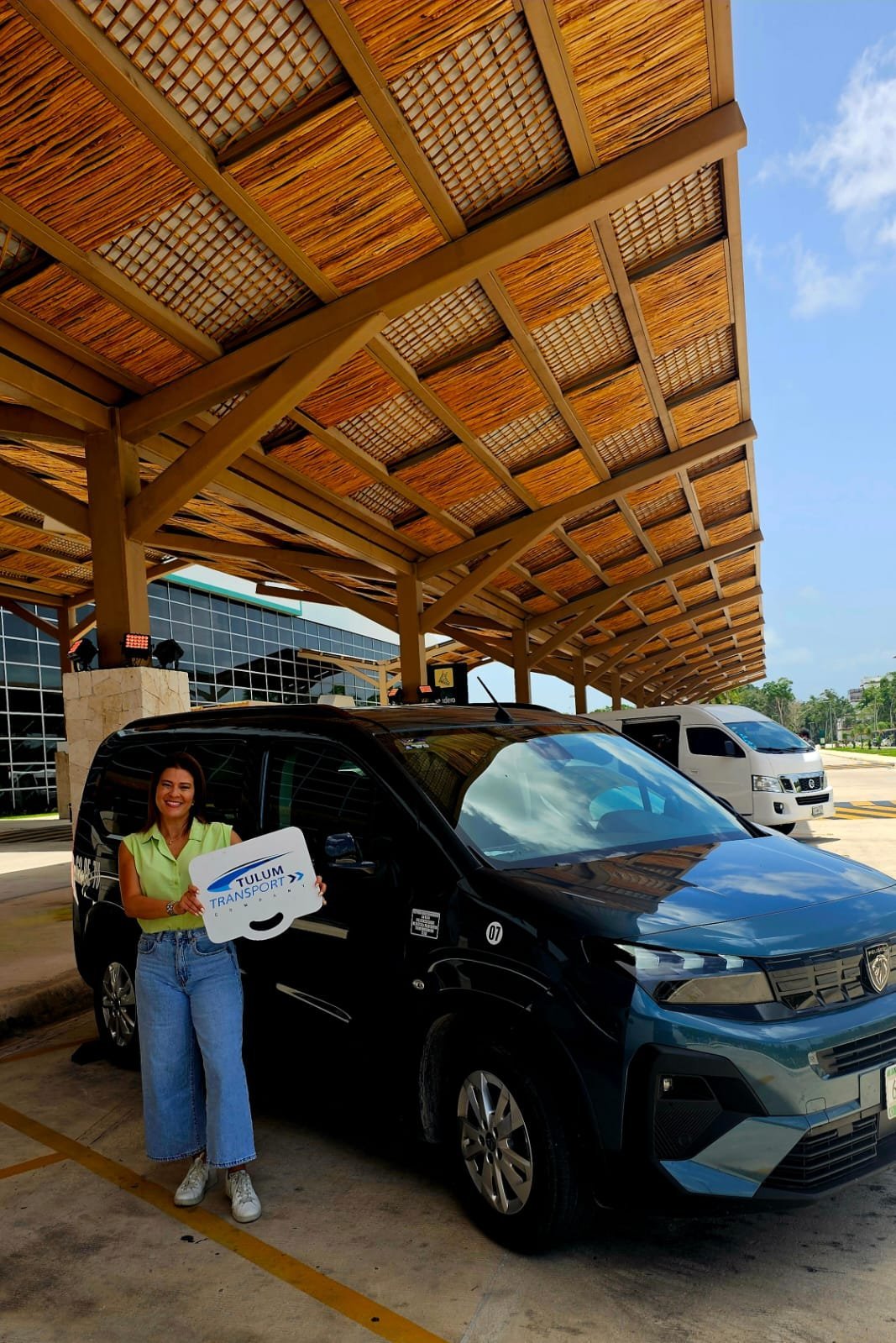 TTC representative holding a guest pickup sign at Tulum International Airport