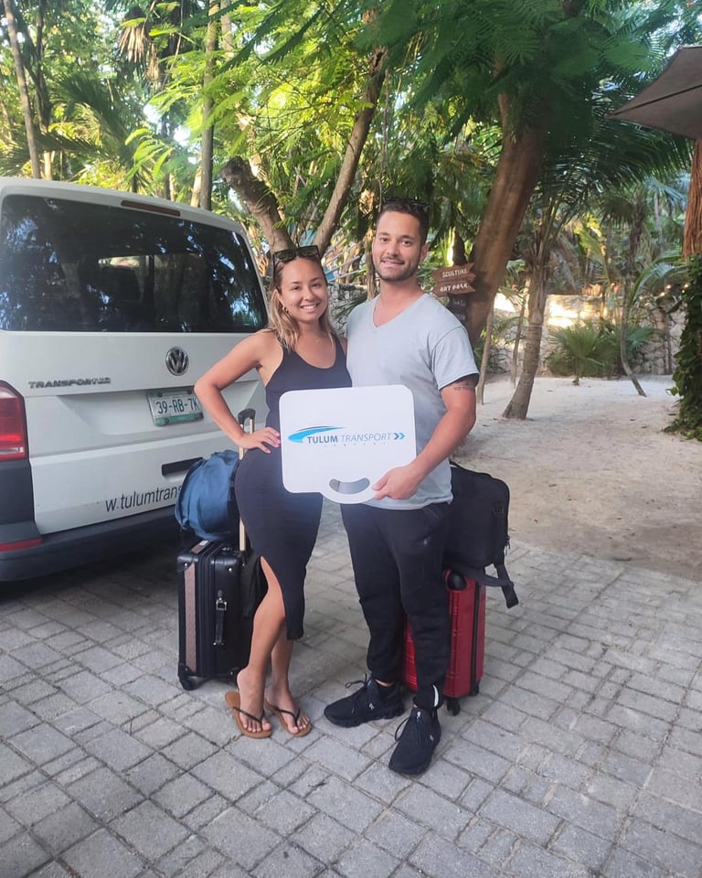 Two travelers with luggage beside a TTC private transfer vehicle in Tulum