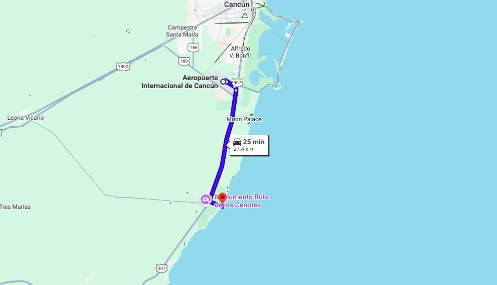 Map showing a route between Cancun International Airport and Puerto Morelos, Mexico with distance and travel markers